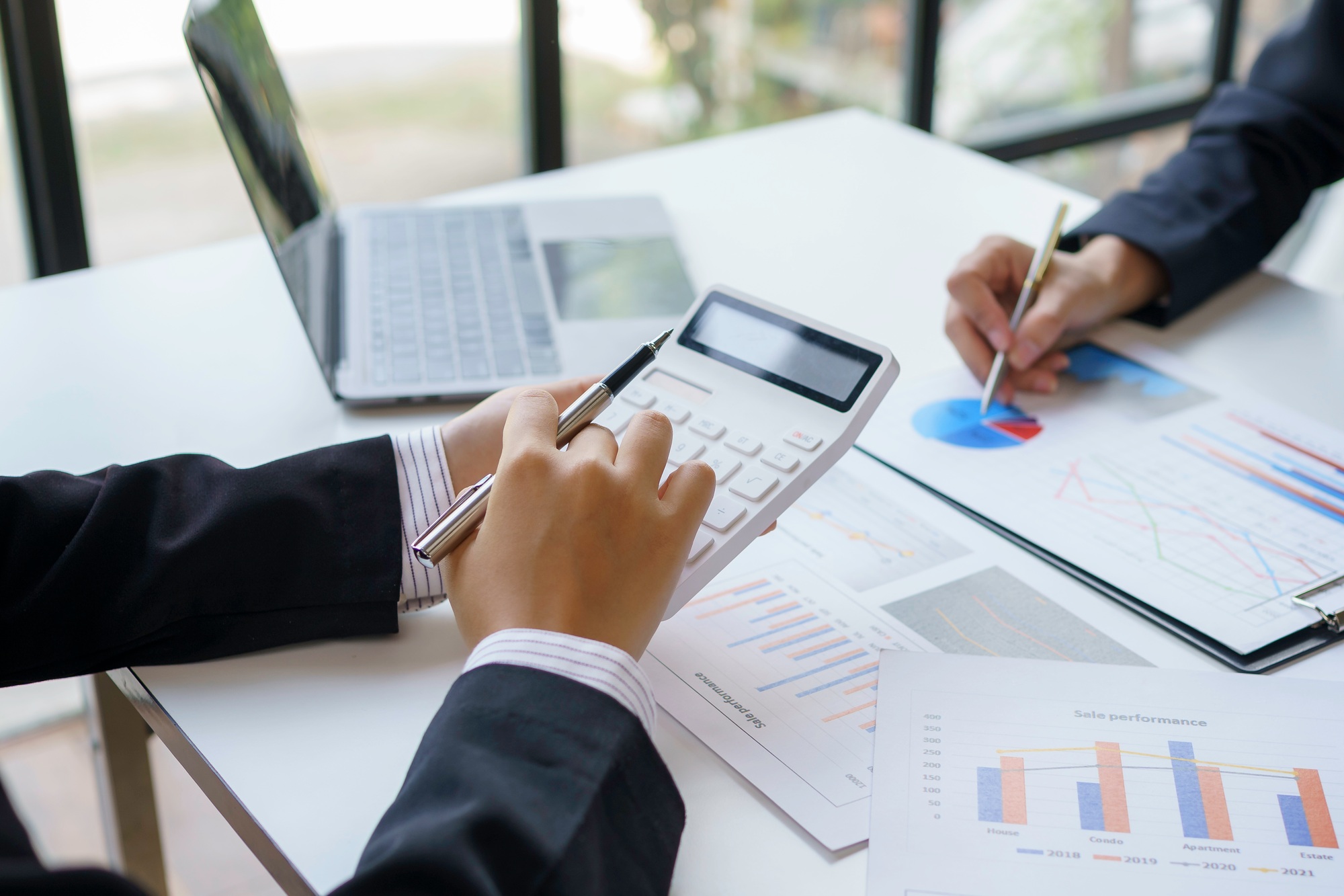 Close-up shot of marketing meeting to analyze and record information, graph, chart, sale strategie,